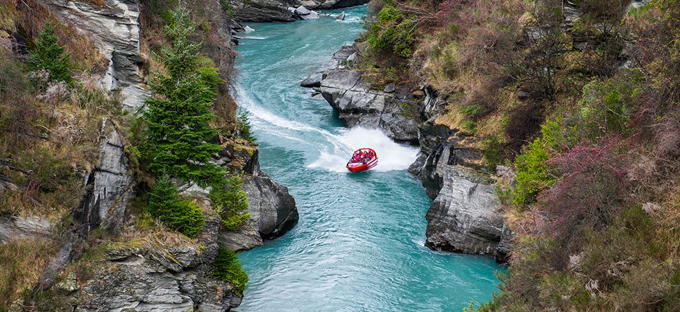 Shotover Jet Boat motoring through a canyon on the Shotover River